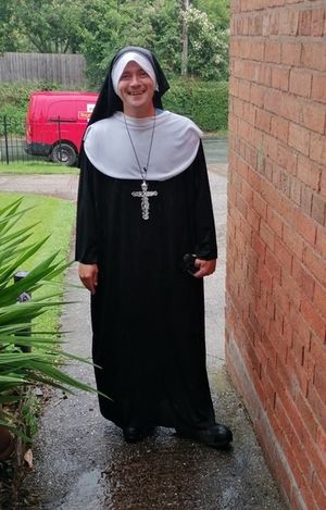 David Hart dressed up as a nun on his postie round