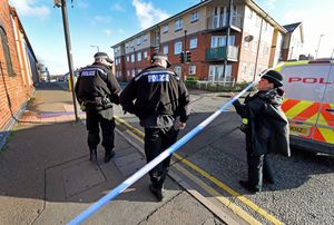 Officer make their way into the cordoned off area to continue their search