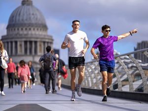 Joggers crossing the Millennium Bridge in London