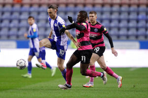 Will Keane of Wigan Athletic and Dan Udoh of Shrewsbury Town (AMA)