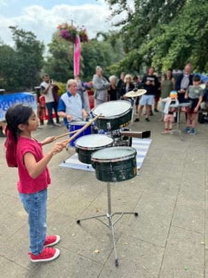 Young girl taking part in the Drumming workshop at the Bridgnoth Music & Arts festival