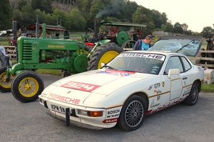 Andrew Meredith's Porsche 924 racing car and Mark Simmonds' John Deere behind