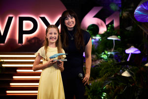 Jamie holding her award with presenter Megan McCubbin 