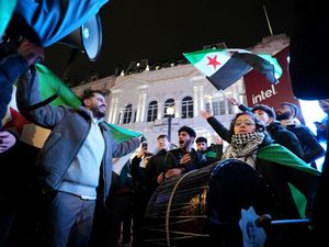 Syrians celebrate the fall of the Assad regime in Piccadilly Circus