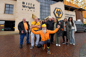 Manny gets ready to walk repeatedly around Molineux with the support of friends and family