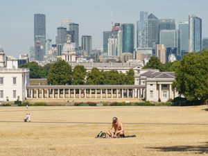 A man sunbathes in a nearly empty Greenwich Park, London (PA)