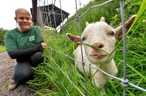 Mia Moore with 16-week-old pygmy goat Phillip