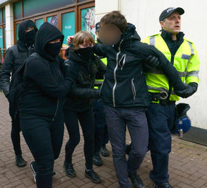 A man is taken away by police during the protest that shut Dudley town centre down