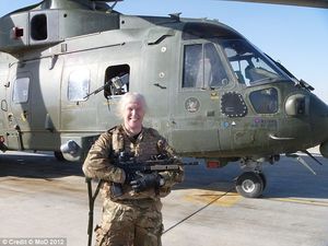 Caroline Paige in front of RAF Helicopter in 2002