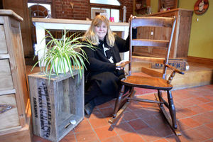 Ann Denton with a vintage rocking chair for sale on the website Reclamation Shop