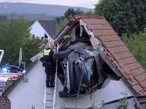 Supporting image for story: Two people seriously injured as car crashes into barn roof in Germany
