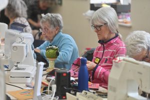 Ladies get to work on their sewing machines