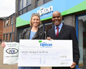 Fundraising officer Amanda Elliott receives Walsall Society for the Blind’s donation from Tipton & Coseley Charitable Foundation trustee Erroll Blackwood