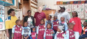 Wing Commander Neil Hope with youngsters in Aston Villa kits donated in Nairobi, Kenya.