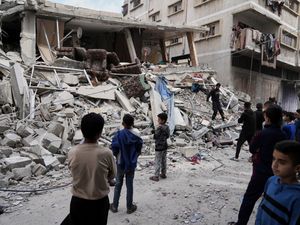 Palestinians inspect the damage after an Israeli army airstrike in Gaza City