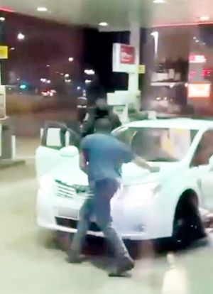 Footage filmed from inside the shop shows the thugs dragging the man out of the white Toyota before appearing to search the back seat