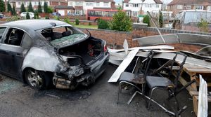 The BMW was torched while it was parked outside the shop