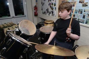 Connor Mynett having fun on the drums