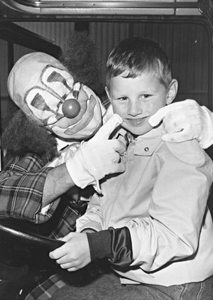 75 years of S Jones Transport Group calls for fun! Clown Frankie Bailey delights five-year-old Gareth Warren at the family day in 1989.