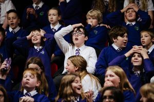 Schoolchildren watching the match