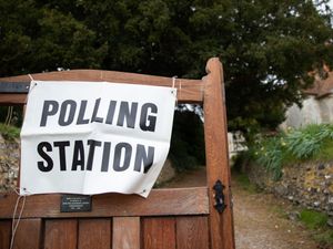 A polling station sign outside a church