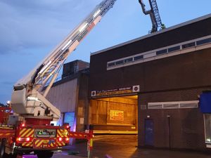 Supporting image for story: Firefighters rescue pair from car park roof after shutters closed