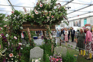 Queen Camilla explores a woven coffin adorned with flowers at the RHS Chelsea Flower Show. Photo credit should read: Toby Melville/PA Wire