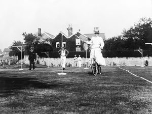 A lady cyclist ring-lancing at the Castle Bowls and Tennis Club on the Linney.