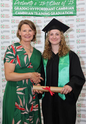 Gabi Wilson receiving her apprenticeship scroll from Cambrian Training Company’s managing director Faith O’Brien at the graduation ceremony
