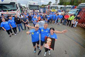 Andrew Day with son Andrew and daughter Kayla, holding Rachel Day's photo, at the convoy in 2021