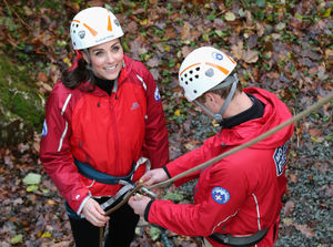 The Duke of Cambridge helps the Duchess of Cambridge after she abseiled down a wall during a visit to the Towers Outdoor Education Centre in 2015.
