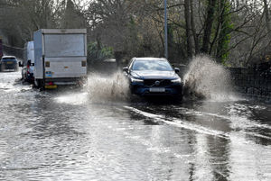 Vehicles push through floodwater on the A41 near Tettenhall. Photo: Tim Thursfield