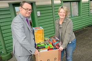 Mark Andrews helps Founder of Harry Johnson Trust Shrewsbury Sally Johnson carry a box of toys
