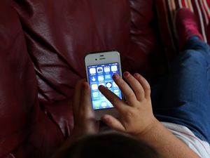 A child using an Apple iPhone smartphone