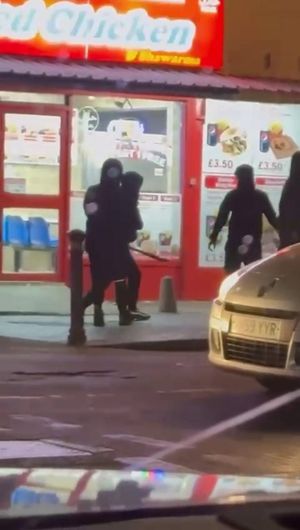 Two men fighting with machetes in the street outside a fried chicken shop on Witton Road, in Aston, Birmingham. 