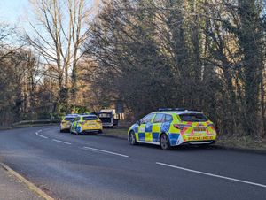 A number of police vehicles are at the scene.