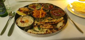 The thali is presented as a big dish with smaller dishes inside