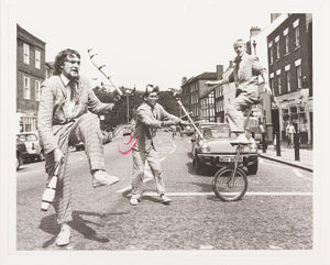 The No Fit State Circus Group, a Cardiff-based street theatre group, brought traffic to a standstill as they gave shows in Kidderminster and Bewdley as part of a programme of activities organised by Wyre Forest Council. The photograph shows Tom Rack, Rick Turner and Peter Gregory (on the unicycle) on a pelican crossing in Bewdley, on August 2, 1988.