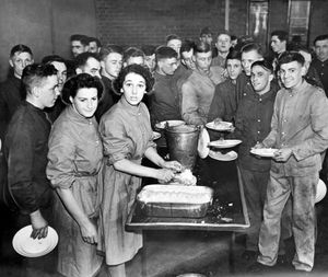 Men queue up for their historic meal.