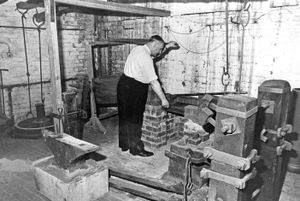 August 1969. The type of small forge used in nail-making and chain-making around the Black Country has been built in what was a metalwork room in Dudley Art Gallery. It has a brick hearth, an Oliver and hand anvils. When it is completed, people visiting the gallery will be able to see it in use.
