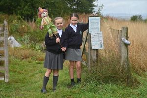 Beatrix Hyde-Follmer (left) and Darcie Ralphs in the school's garden with a scarecrow