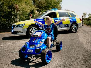 Supporting image for story: Ben, four, flanked by soldiers as he celebrates 11-mile Telford pedal for the NHS