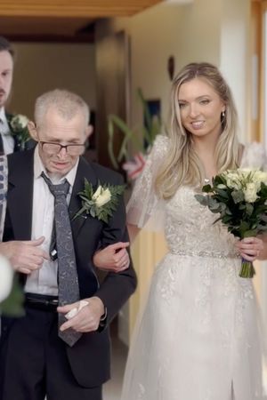 Maurice Haynes walks his daughter Hannah down the aisle at St Giles Hospice in Whittington, Shropshire.