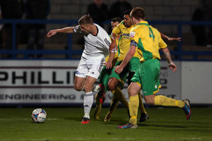 Mike Phenix of AFC Telford United wrestles his way past three Vauxhall Motors defenders.