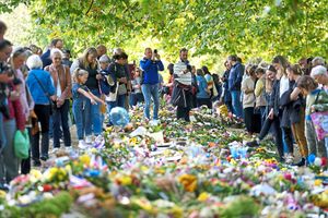 Members of the public place flowers in Green Park, close to Buckingham Palace, on the eve of the funeral