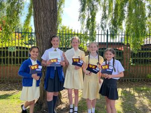 Five girls holding their letters from veterans