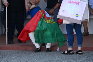 A mourner draped in the flag of Portugal at the wake of Diogo Jota being held at Sao Cosme Chapel in the town of Gondomar near Porto