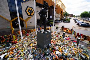The iconic Billy Wright statue is surrounded by shirts, scarves and flowers