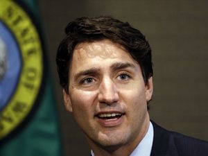 Supporting image for story: Justin Trudeau ended up in students' prom picture while out jogging and Twitter's loving it