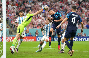 Argentina goalkeeper Emiliano Martinez (left) clears the ball from Croatia's Dejan Lovren